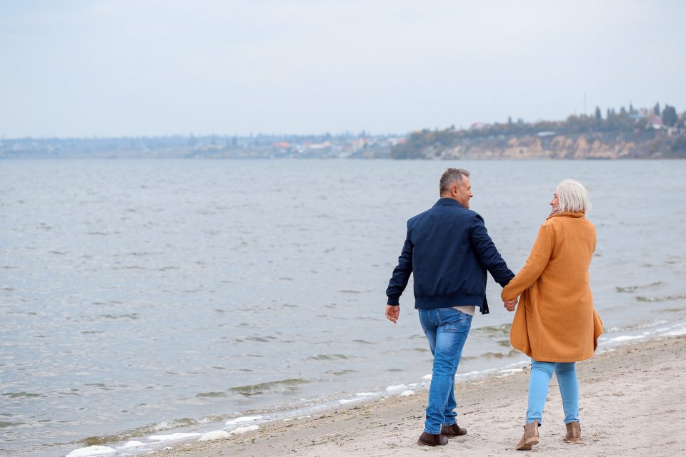 Couple walking hand in hand on a beach