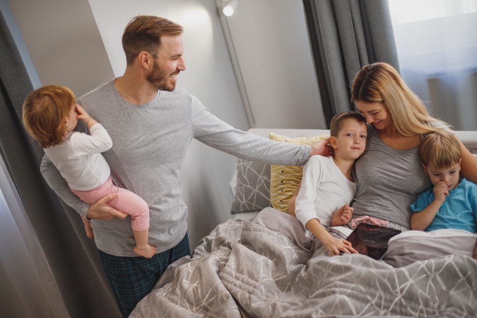 Parents and children looking at a tablet together