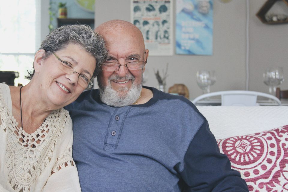 Smiling retired couple at home